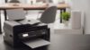 New,Modern,Printer,On,Table,In,Office.,Space,For,Text