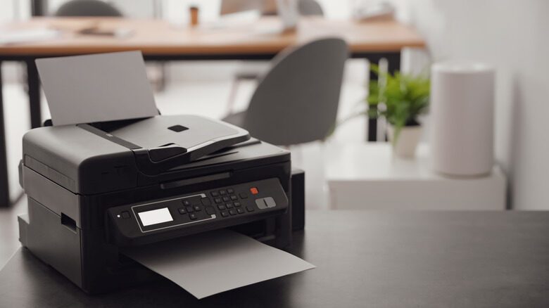 New,Modern,Printer,On,Table,In,Office.,Space,For,Text
